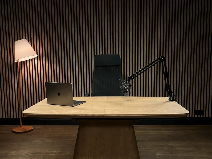 Solo zone — a desk with a boom-arm microphone and a laptop